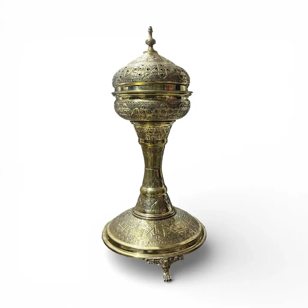 Handmade Moroccan brass incense burner with hand engraved details displayed in a modern living room