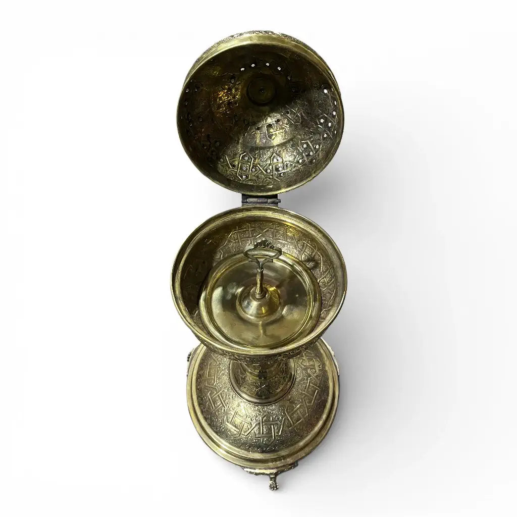 Handmade Moroccan brass incense burner with hand engraved details displayed in a modern living room