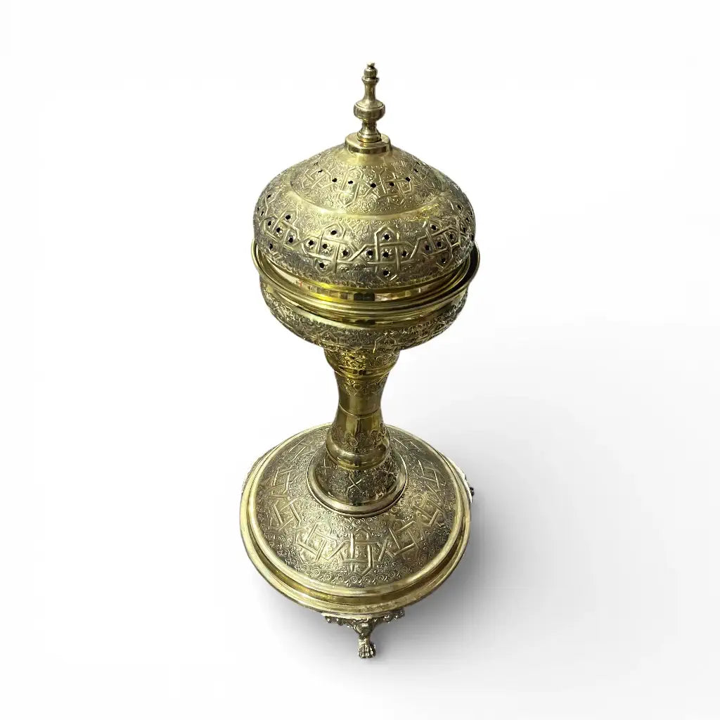 Handmade Moroccan brass incense burner with hand engraved details displayed in a modern living room
