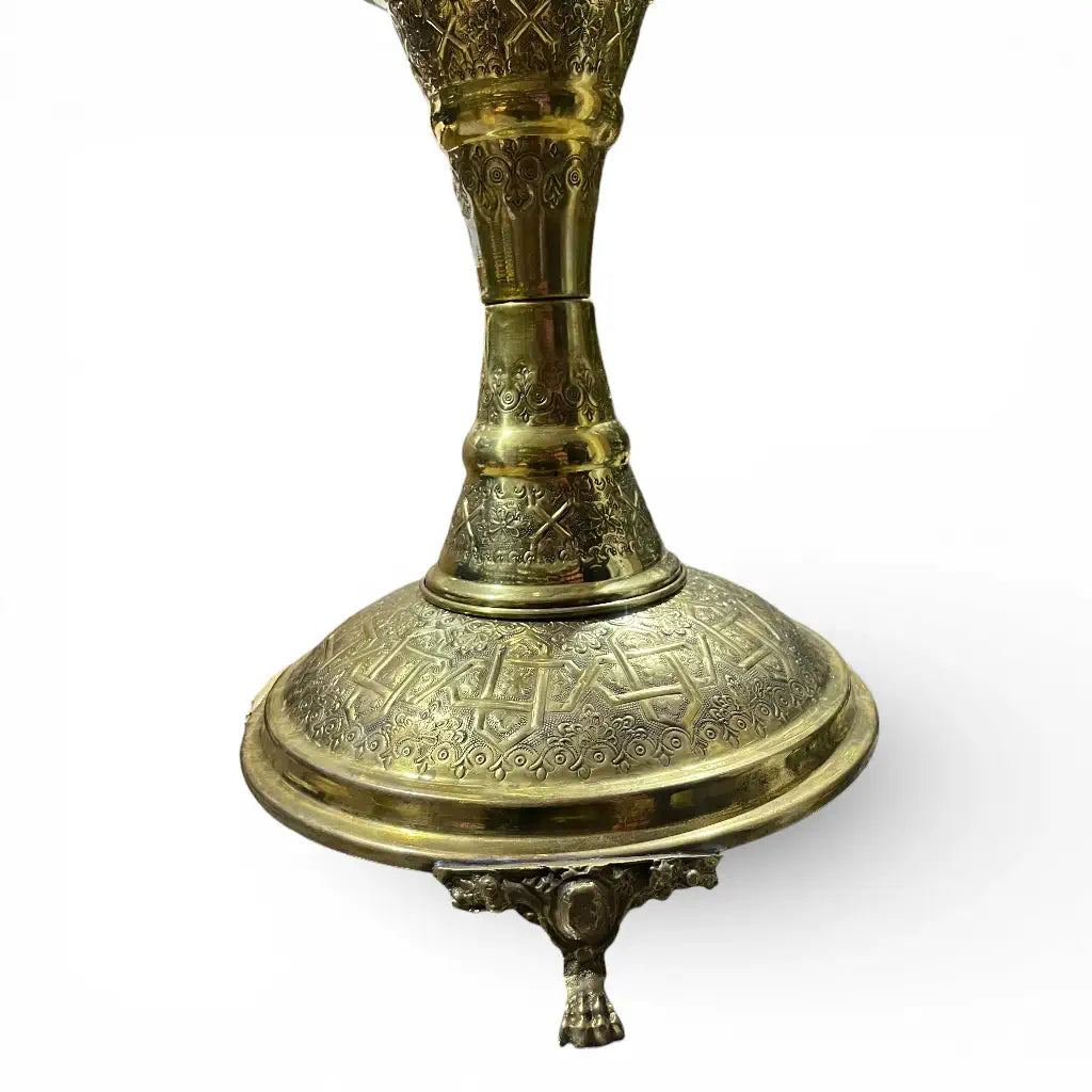 Handmade Moroccan brass incense burner with hand engraved details displayed in a modern living room
