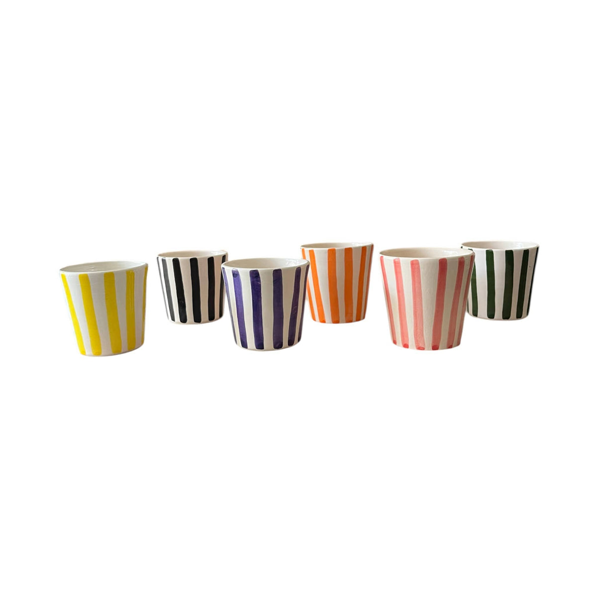 Set of seven colorful striped cups on a white background