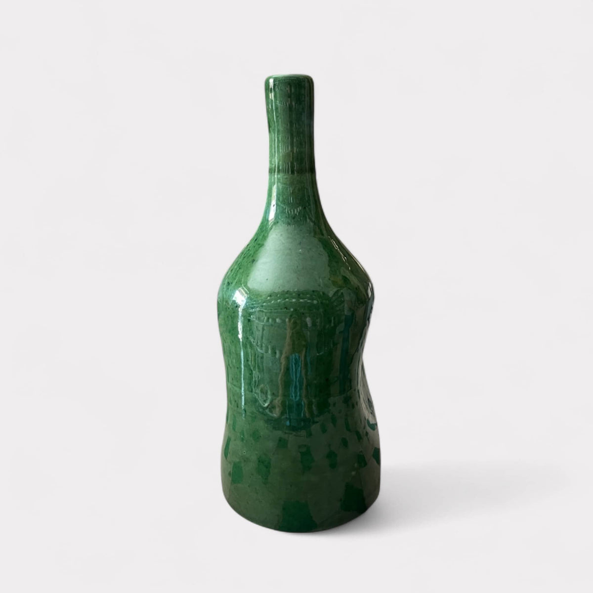 Green ceramic bottle-shaped vase on a white background