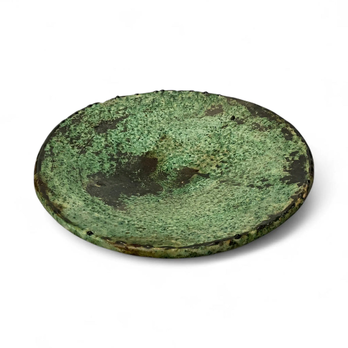 Round greenish plate on a white background