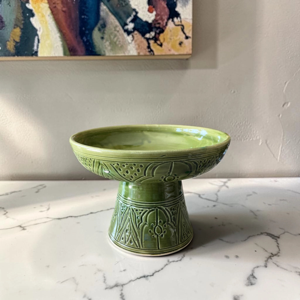 Handmade green ceramic pedestal bowl with hand-engraved Moroccan patterns
