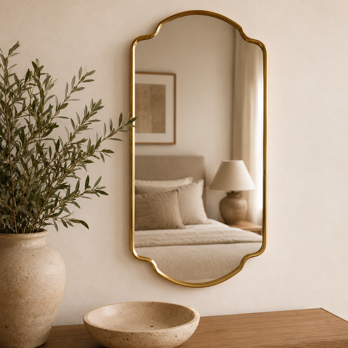Handmade antique brass arched wall mirror with stepped Moroccan inspired frame.