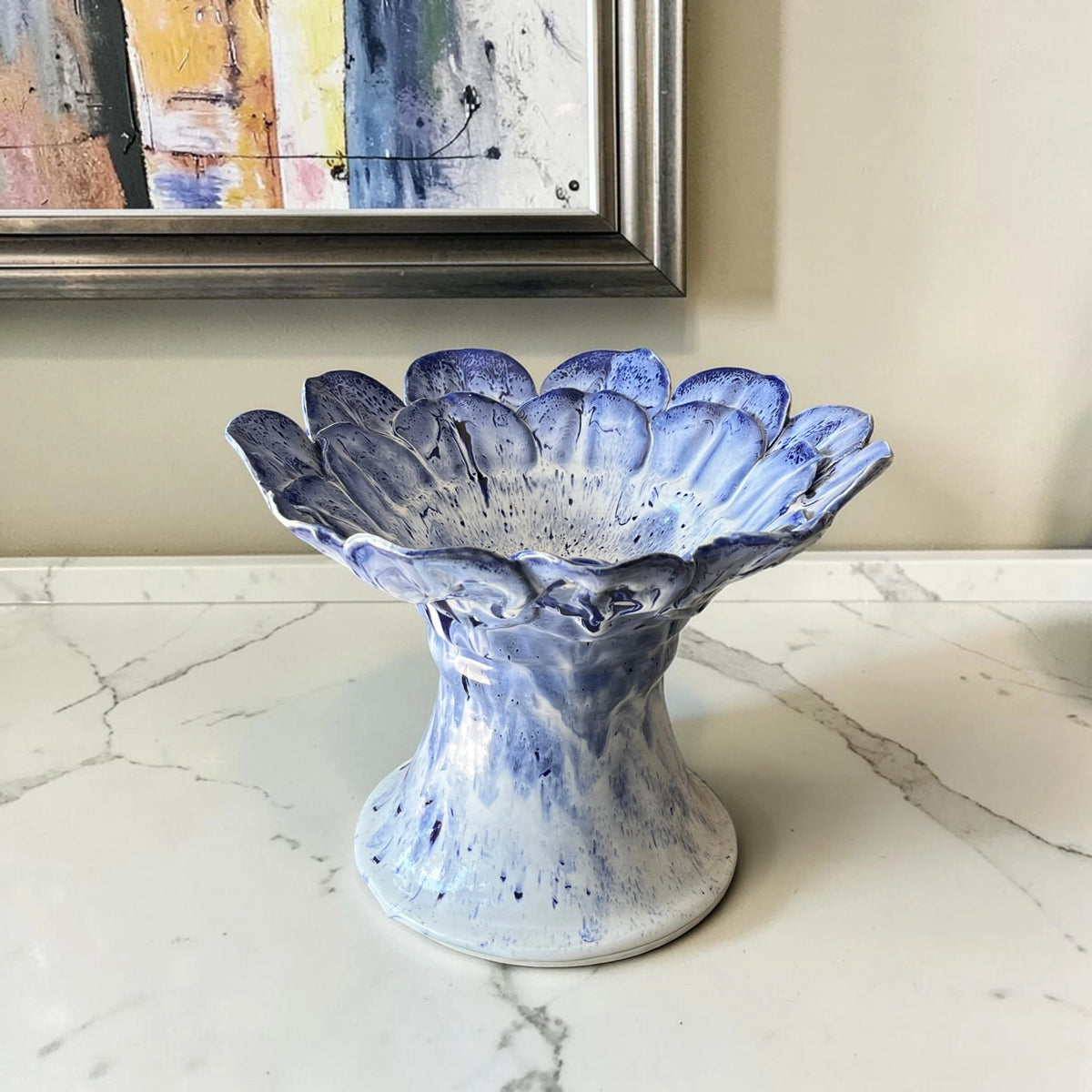 Handmade blue ceramic pedestal bowl with flower-inspired sculptural design