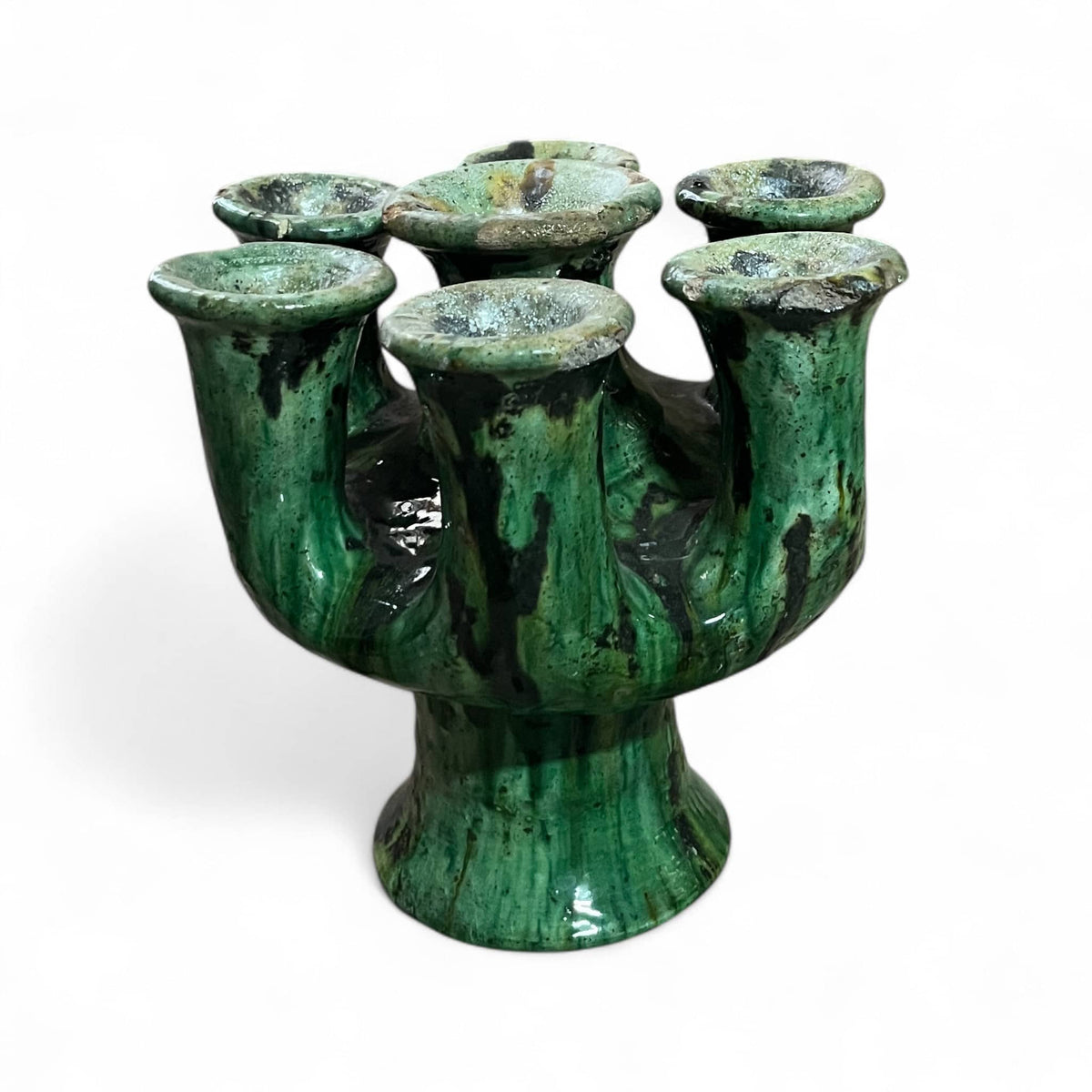 Green ceramic vase with multiple nozzles on a white background