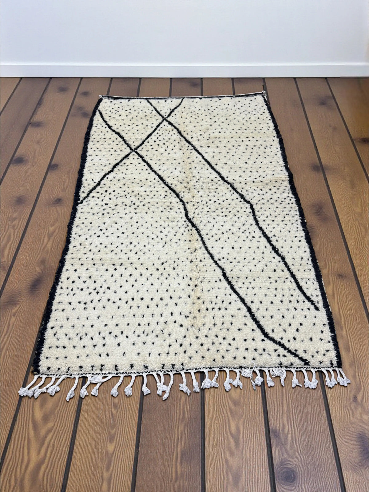 Handwoven Moroccan Azilal carpet in ivory wool with black dotted and linear patterns, 252 × 158 cm