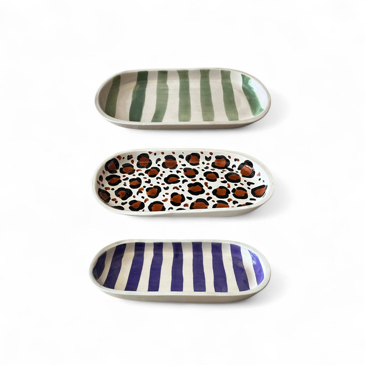 Three ceramic trays with different patterns on a white background