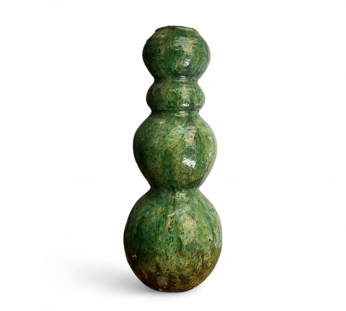 Green ceramic vase with three spherical sections on a white background