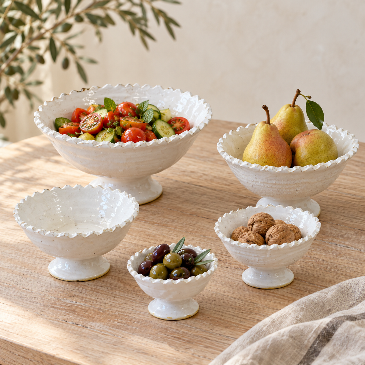 White Tamegroute ceramic pedestal fruit bowl with a jagged rim, handmade in Morocco.