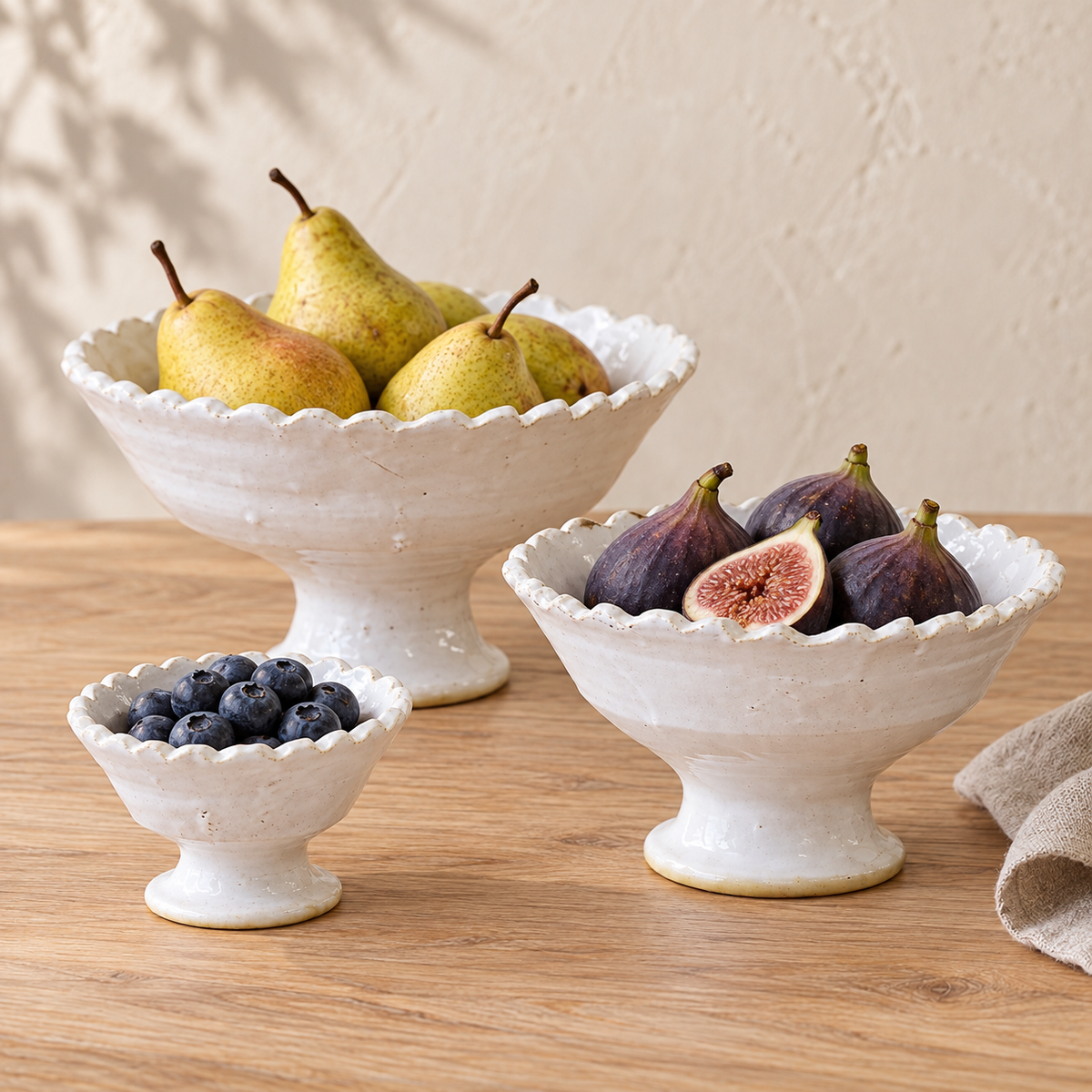 White Tamegroute ceramic pedestal fruit bowl with a jagged rim, handmade in Morocco.