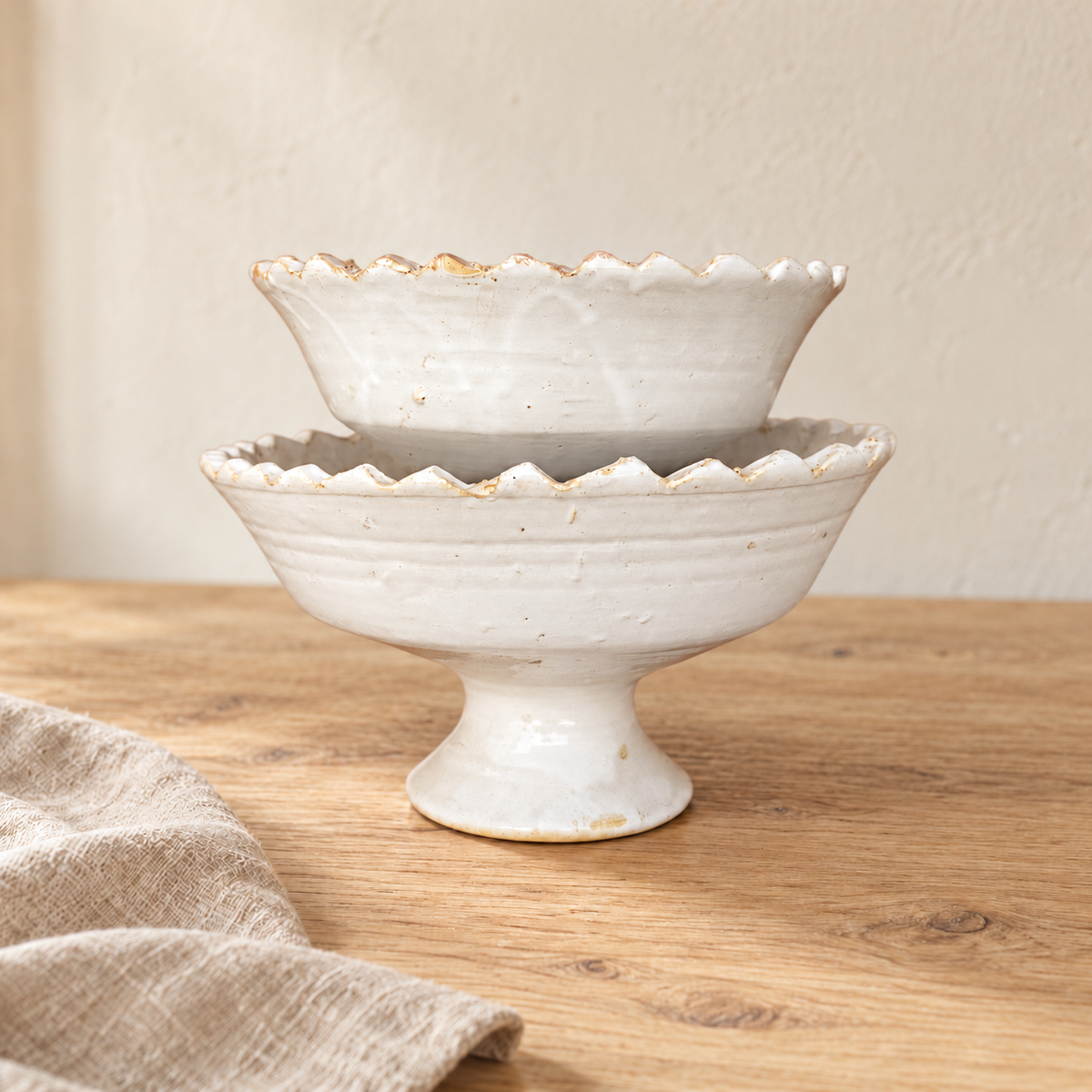 White Tamegroute ceramic pedestal fruit bowl with a jagged rim, handmade in Morocco.