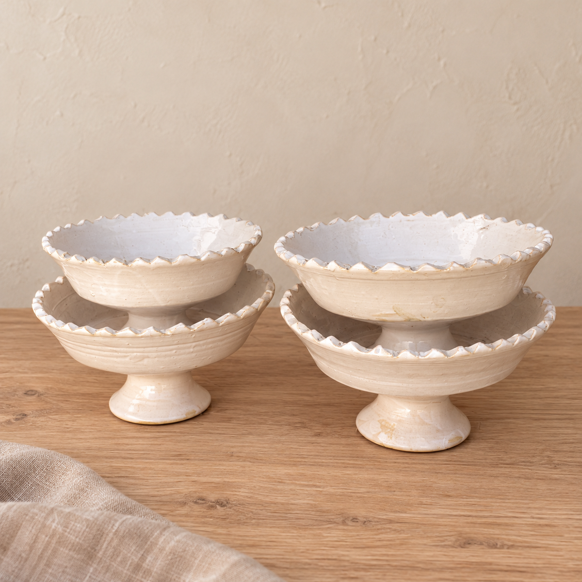 White Tamegroute ceramic pedestal fruit bowl with a jagged rim, handmade in Morocco.