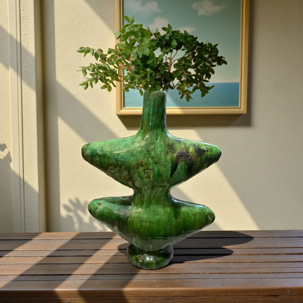 Handmade Tamegroute ceramic vase with sculptural form and natural green glaze, crafted in Morocco