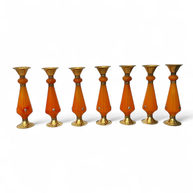 Set of seven Amber resin and brass candlestick with flared top and sunburst medallion, 22 cm tall vintage decorative candle holder  on a white background