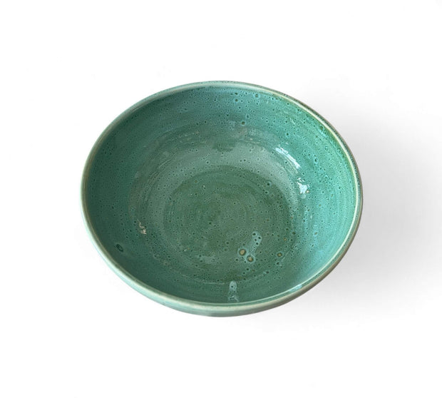 Green ceramic bowl on a white background