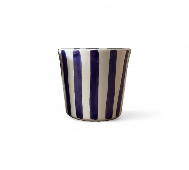 Ceramic cup with purple and white vertical stripes on a white background