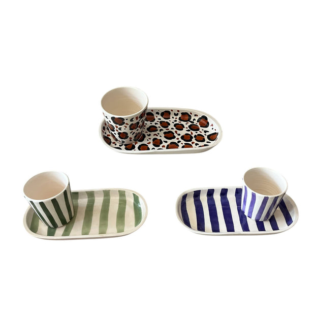 Set of ceramic dishes with animal print and striped patterns on a white background