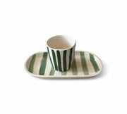 Ceramic cup and saucer with green stripes on a white background