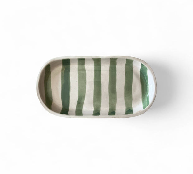 Rectangular ceramic dish with green and white stripes on a white background