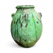 Green ceramic vase with a textured surface on a white background
