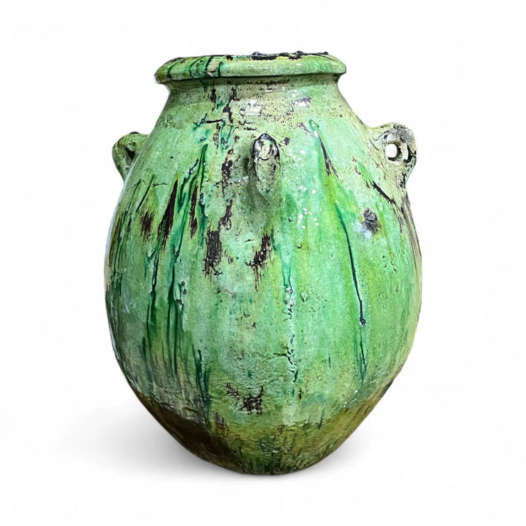 Green ceramic vase with a textured surface on a white background