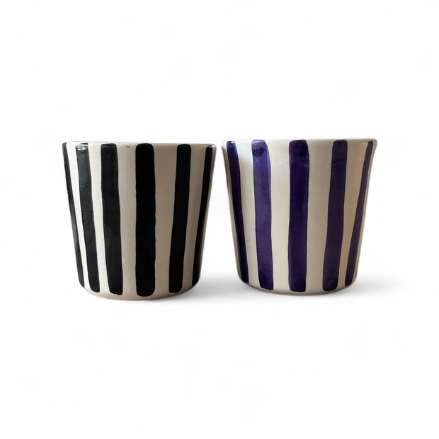 Two ceramic cups with black and purple stripes on a white background