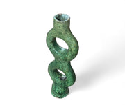 Green ceramic vase with a twisted design on a white background