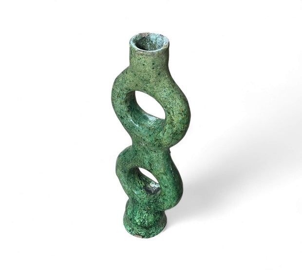 Green ceramic vase with a twisted design on a white background