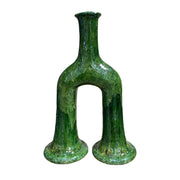 Green glass vase with unique design on a white background