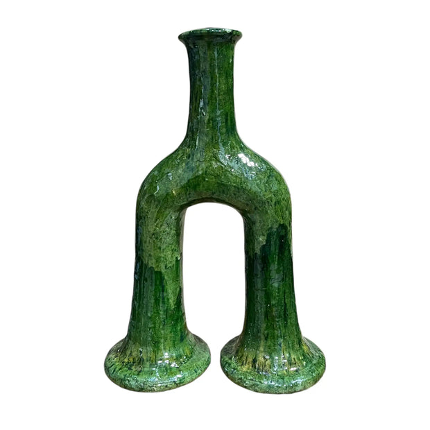 Green glass vase with unique design on a white background