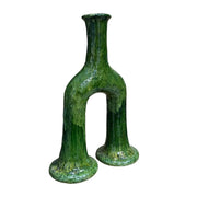 Green ceramic vase with a unique design on a white background