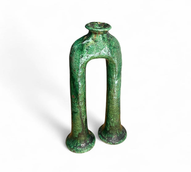 Green ceramic vase with unique design on a white background