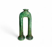 Green ceramic vase with a unique design on a white background