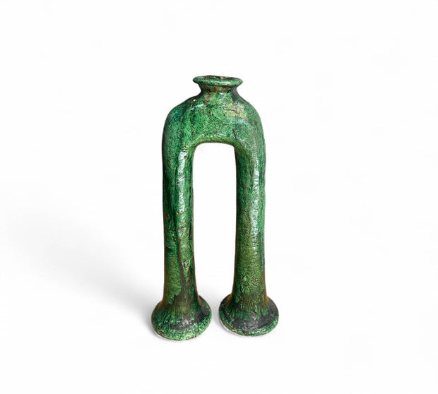 Green ceramic vase with a unique design on a white background