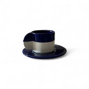Navy blue and white ceramic cup and saucer on a white background