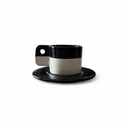Black and white ceramic cup and saucer on a white background