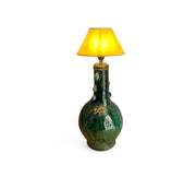 Green ceramic lamp with a yellow lampshade on a white background