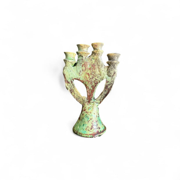 Decorative ceramic candelabra with a green and brown glaze on a white background