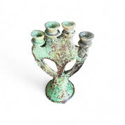 Vintage-style candle holder with a patina finish on a white background