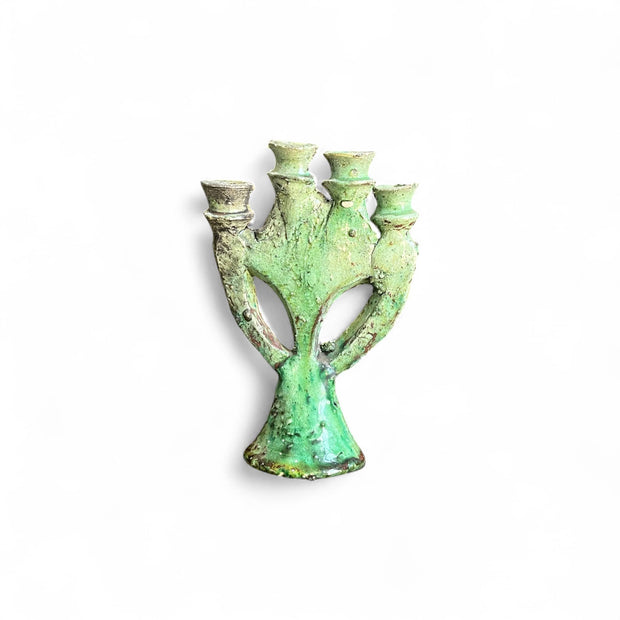 Green ceramic vase with three outlets on a white background