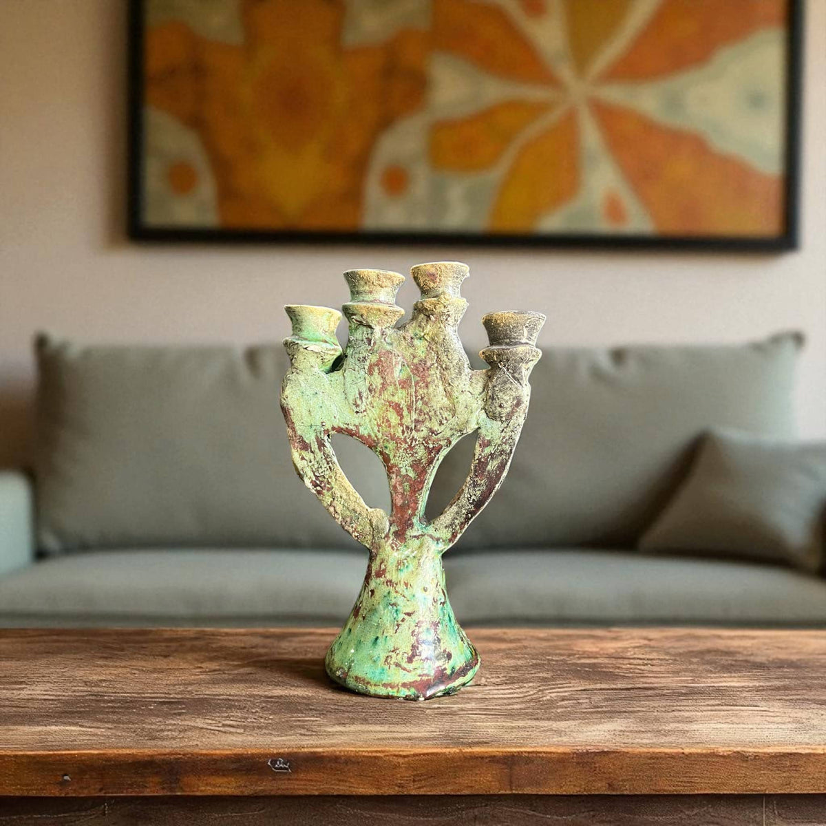 Vintage-style green candle holder on a wooden surface with a blurred background