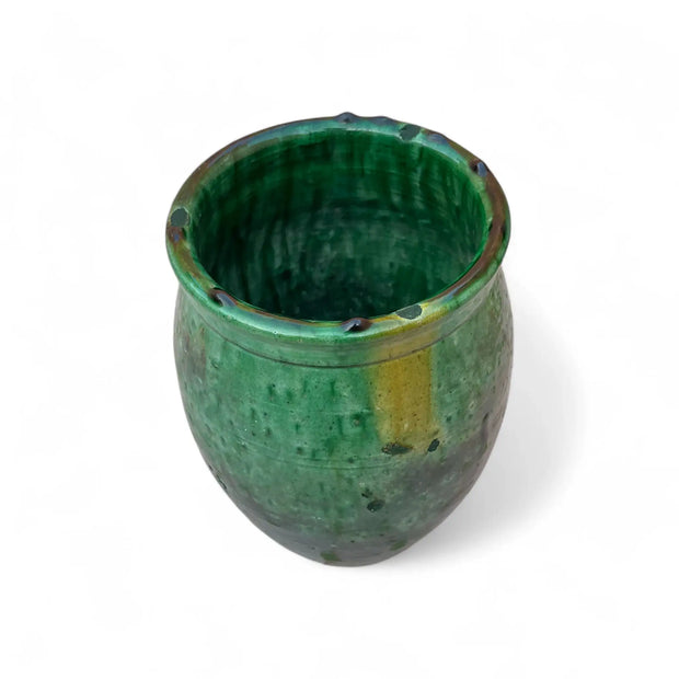 Green ceramic cup on a white background