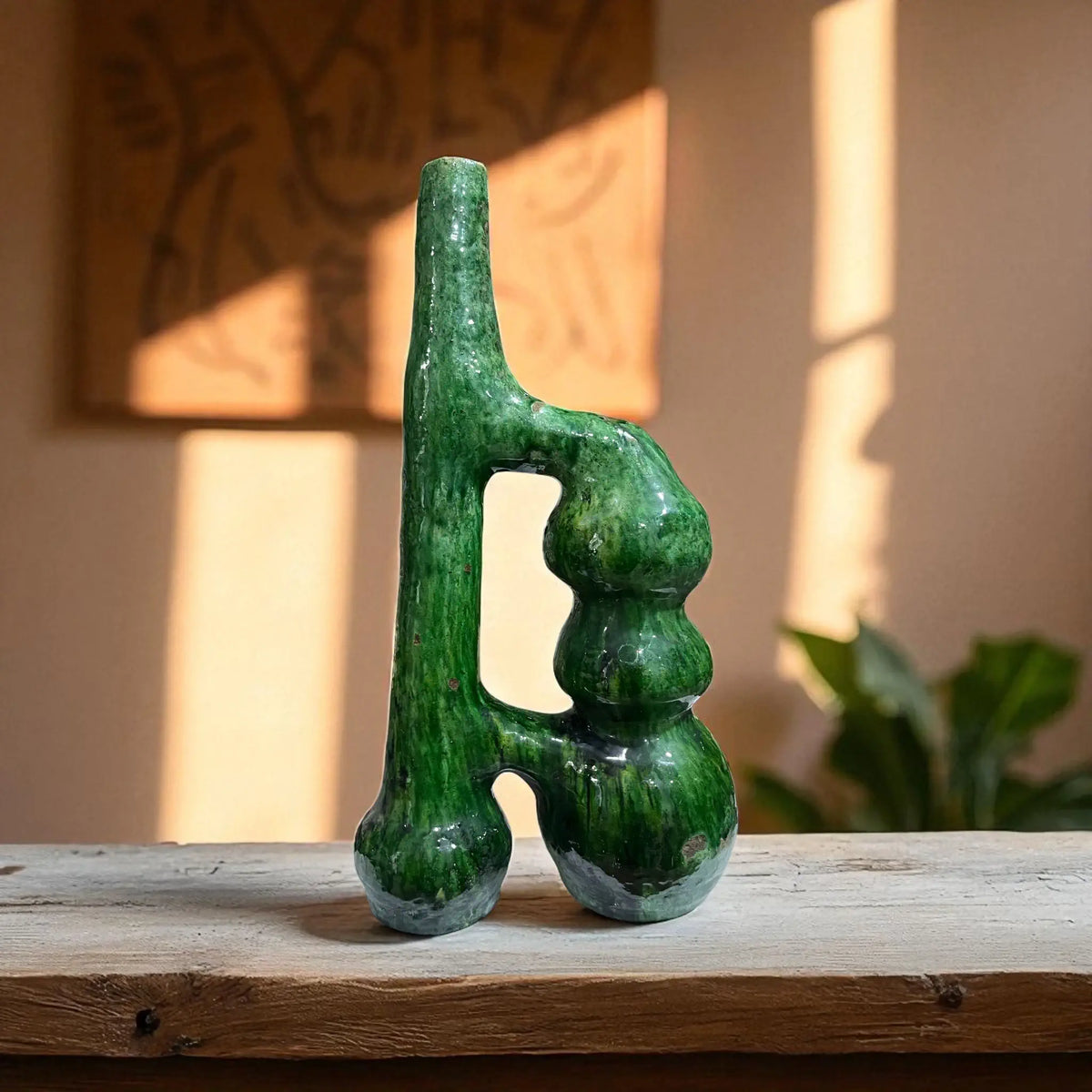 Green Abstract Tamegroute Vase a wooden surface with a blurred background