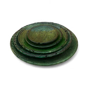 Set of three green ceramic plates stacked on a white background