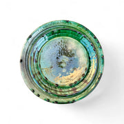 Green ceramic bowl with a textured surface on a white background