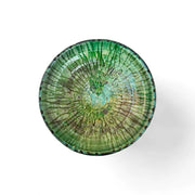 Green ceramic plate with a unique pattern on a white background