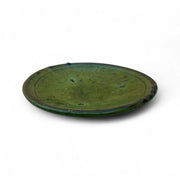 Green ceramic plate on a white background