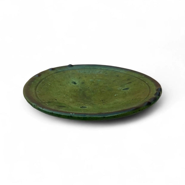 Green ceramic plate on a white background